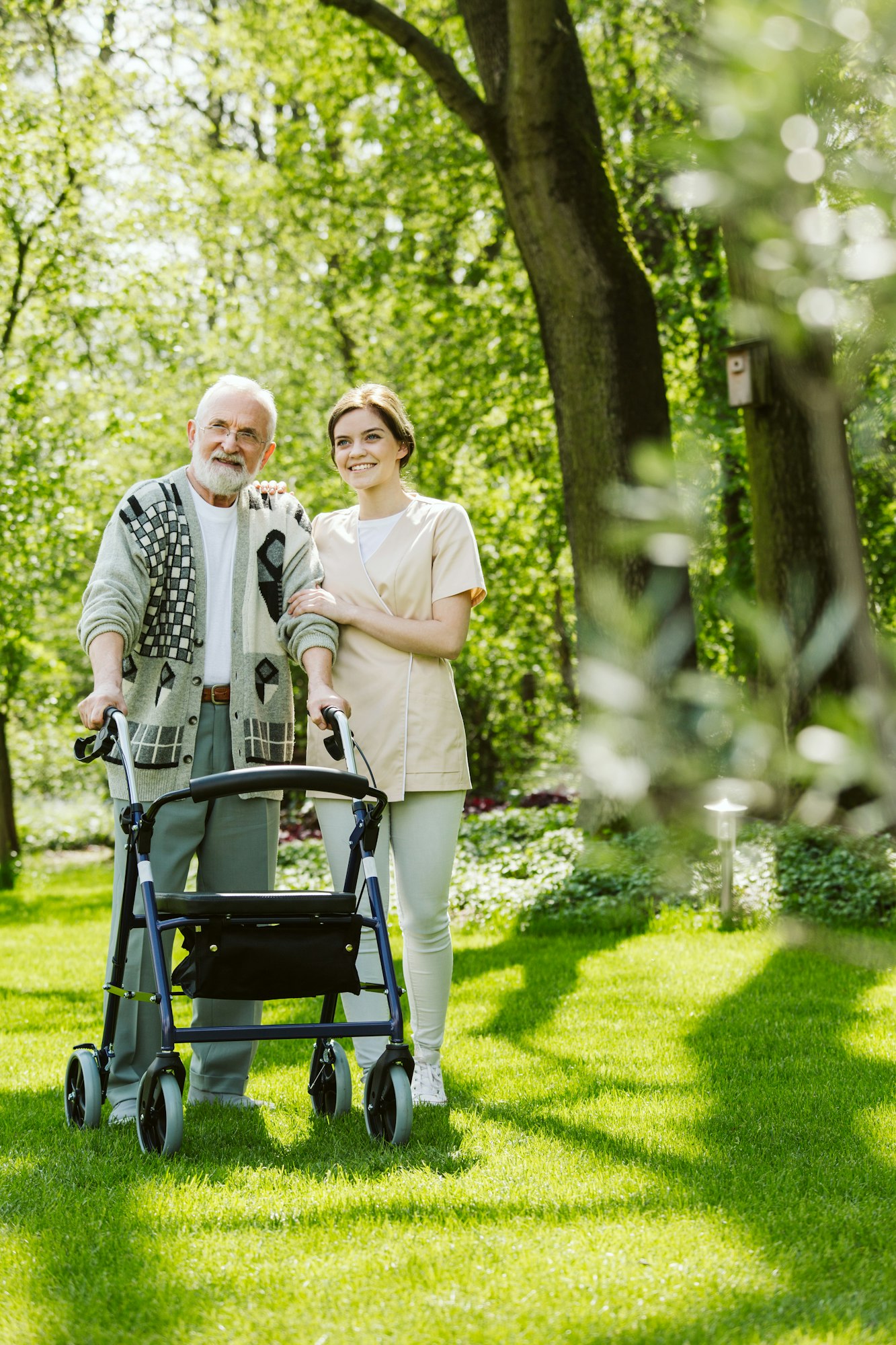 Nurse and patient in the garden of modern senior home with daily care